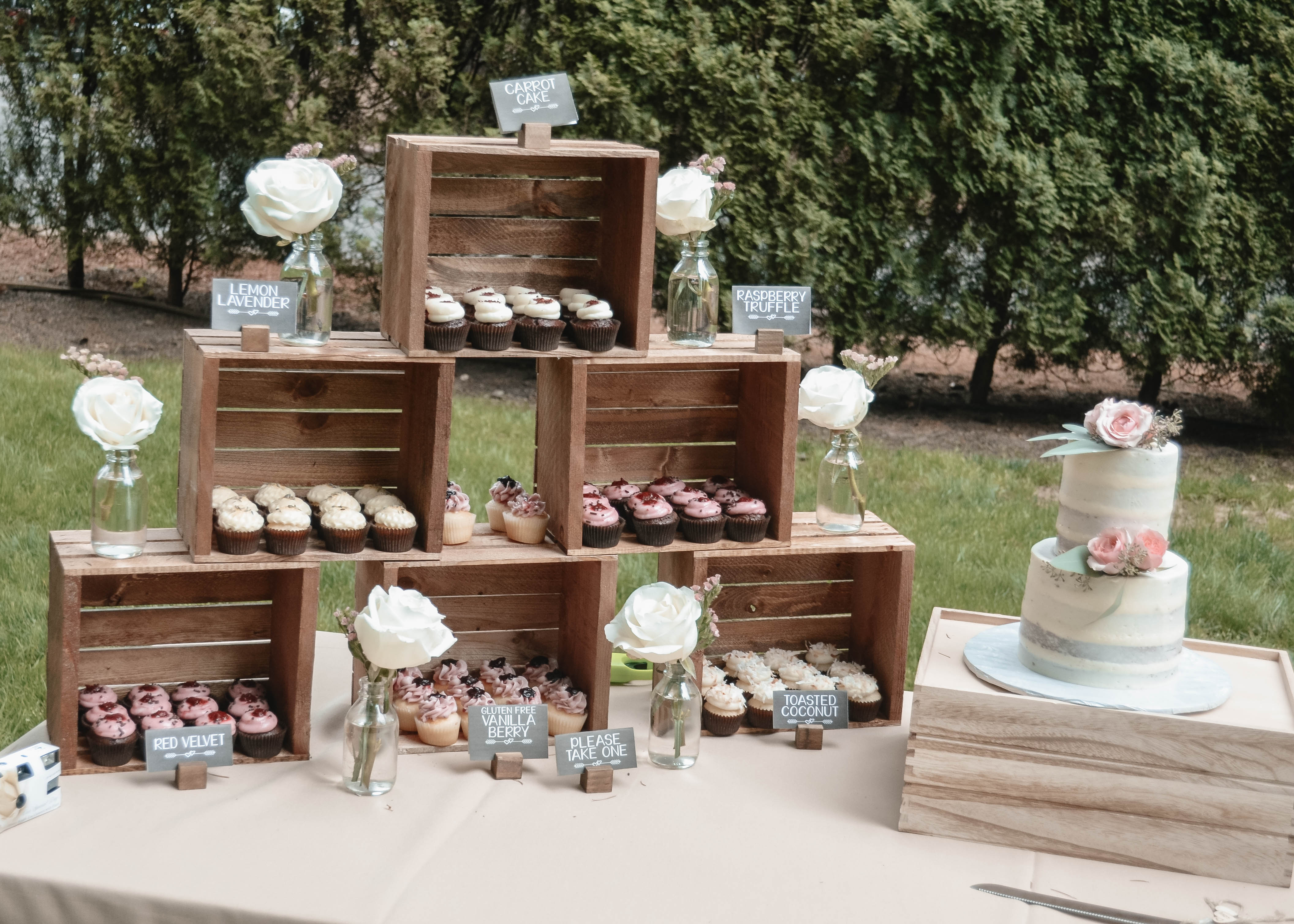 Rustic dessert table with white roses in bud vases